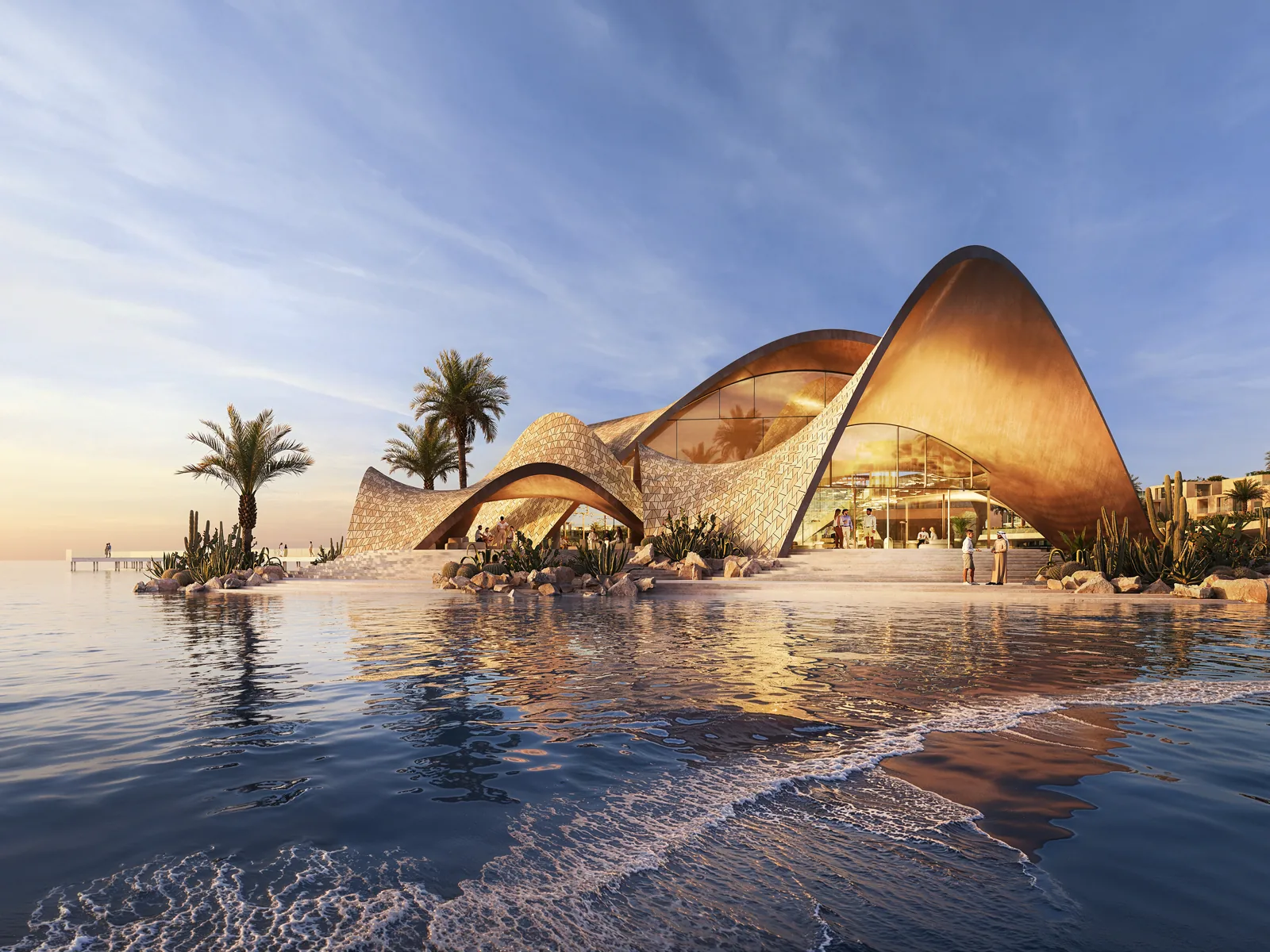 The shell-roofed beach club at the water's edge at sunset, its curved vaults drawn from coral